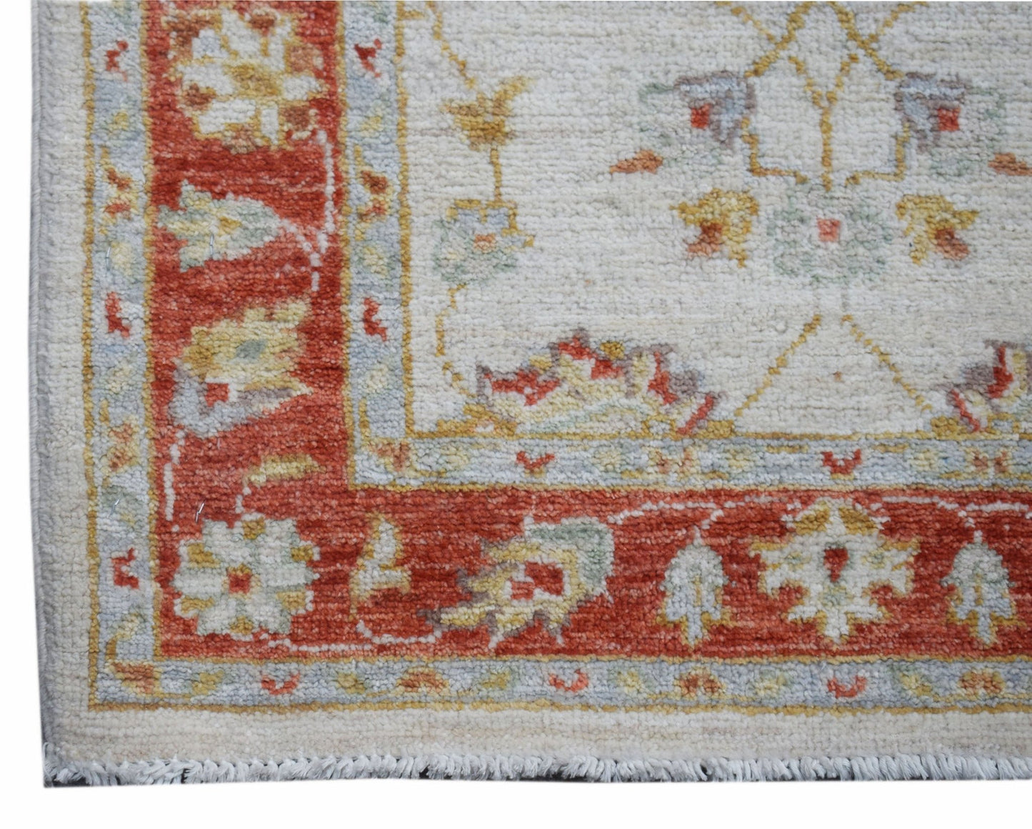 A handmade Afghan Chobi runner featuring a traditional floral pattern in red, cream, and gold.
