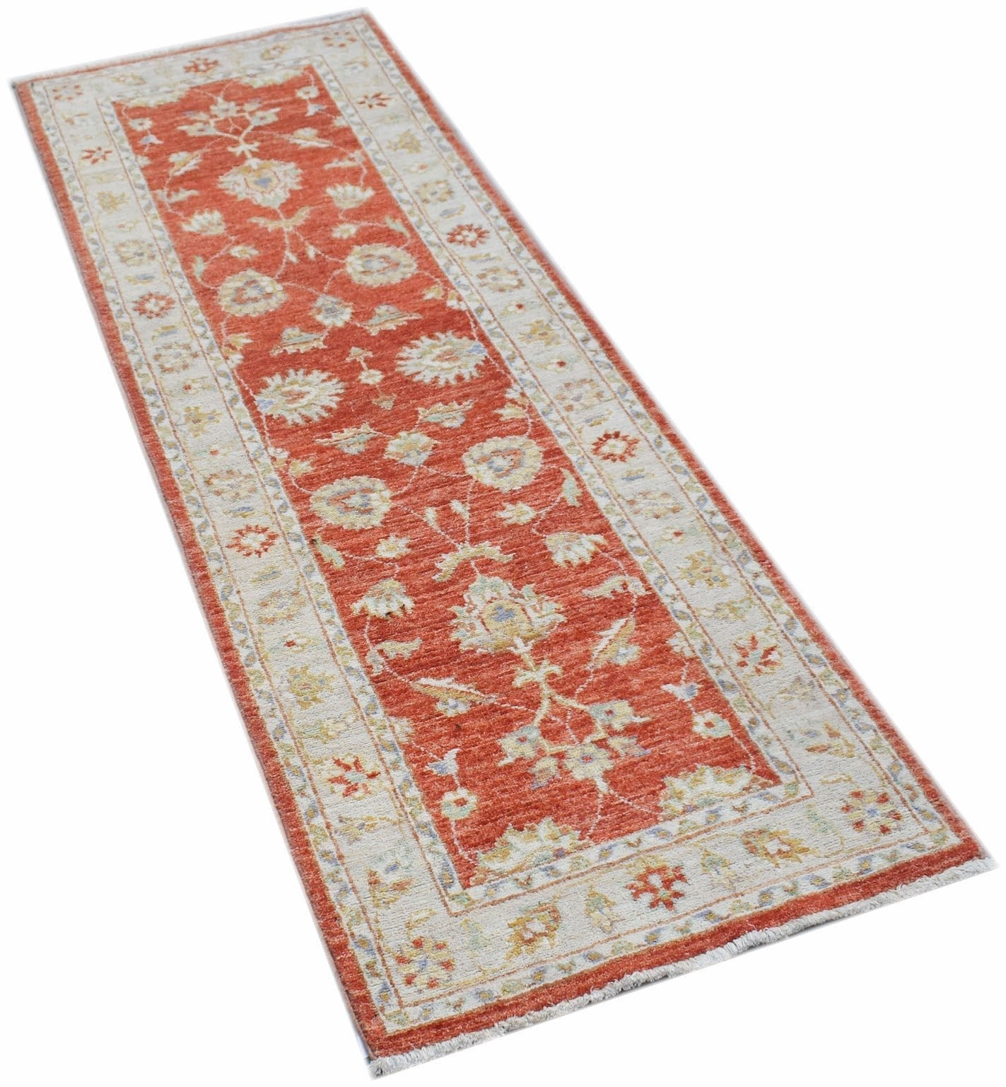 A handmade Afghan Chobi runner rug featuring a traditional floral pattern in red and cream tones.