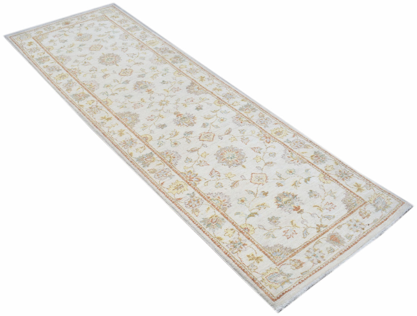 A handmade Afghan Chobi runner rug featuring a traditional floral pattern in soft, earthy tones.