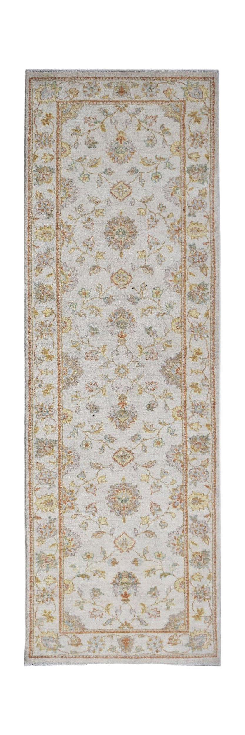 A handmade Afghan Chobi runner rug featuring a traditional floral pattern in soft earthy tones.