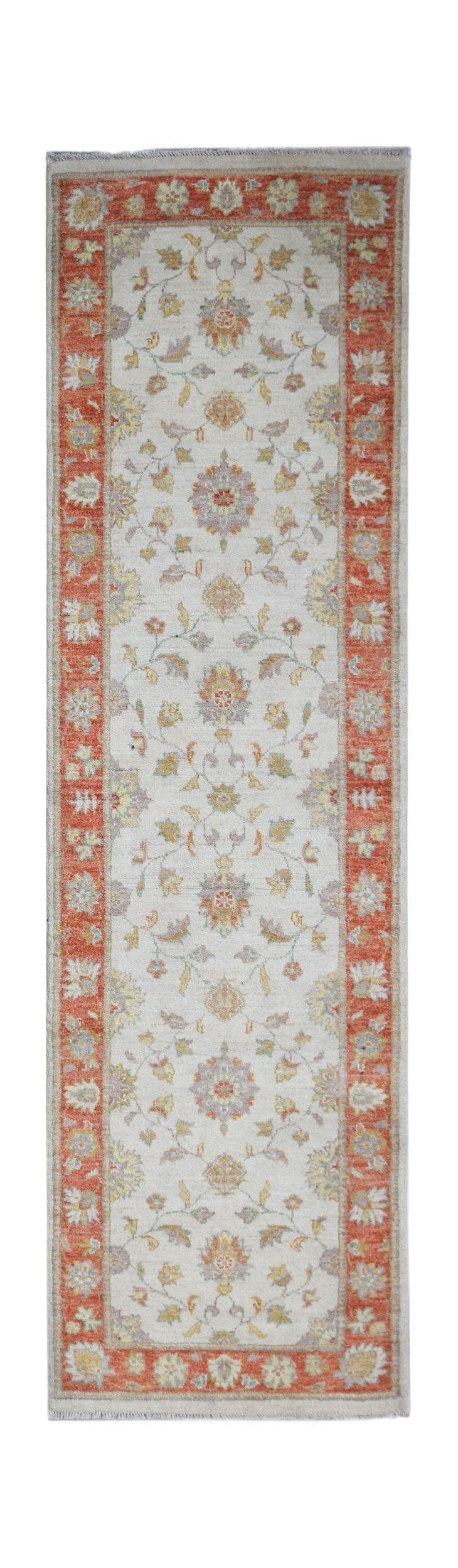 A handmade Afghan Chobi runner rug featuring a floral pattern in muted tones on a cream background.