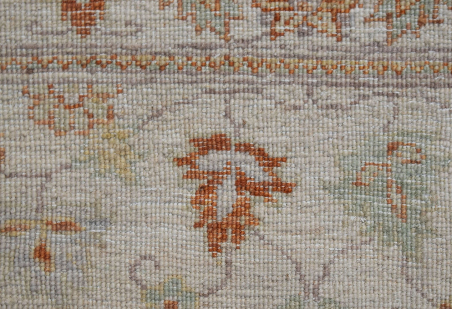A close-up view of an Afghan Chobi runner featuring traditional floral patterns in earthy tones.