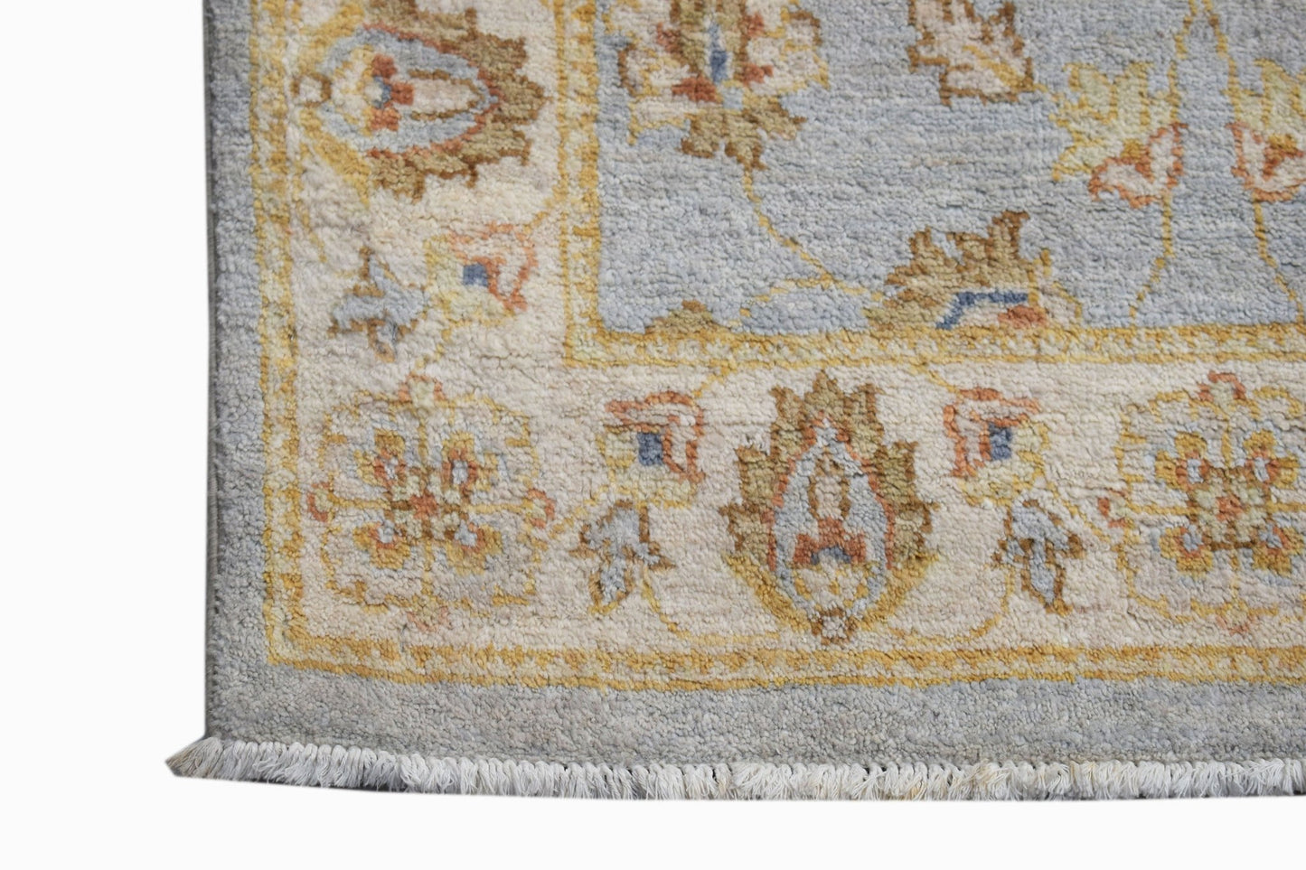 A handwoven Afghan Chobi runner featuring a light blue field with traditional floral patterns.