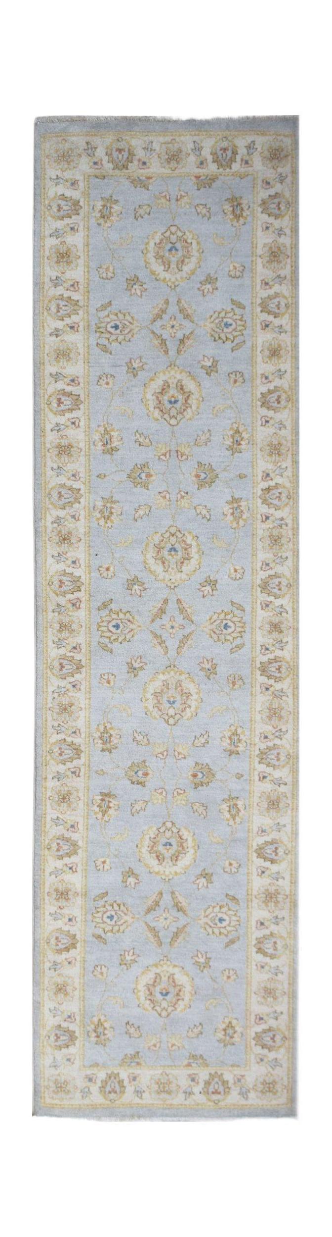A handmade Afghan Chobi runner rug featuring a traditional floral pattern in soft blue and beige.