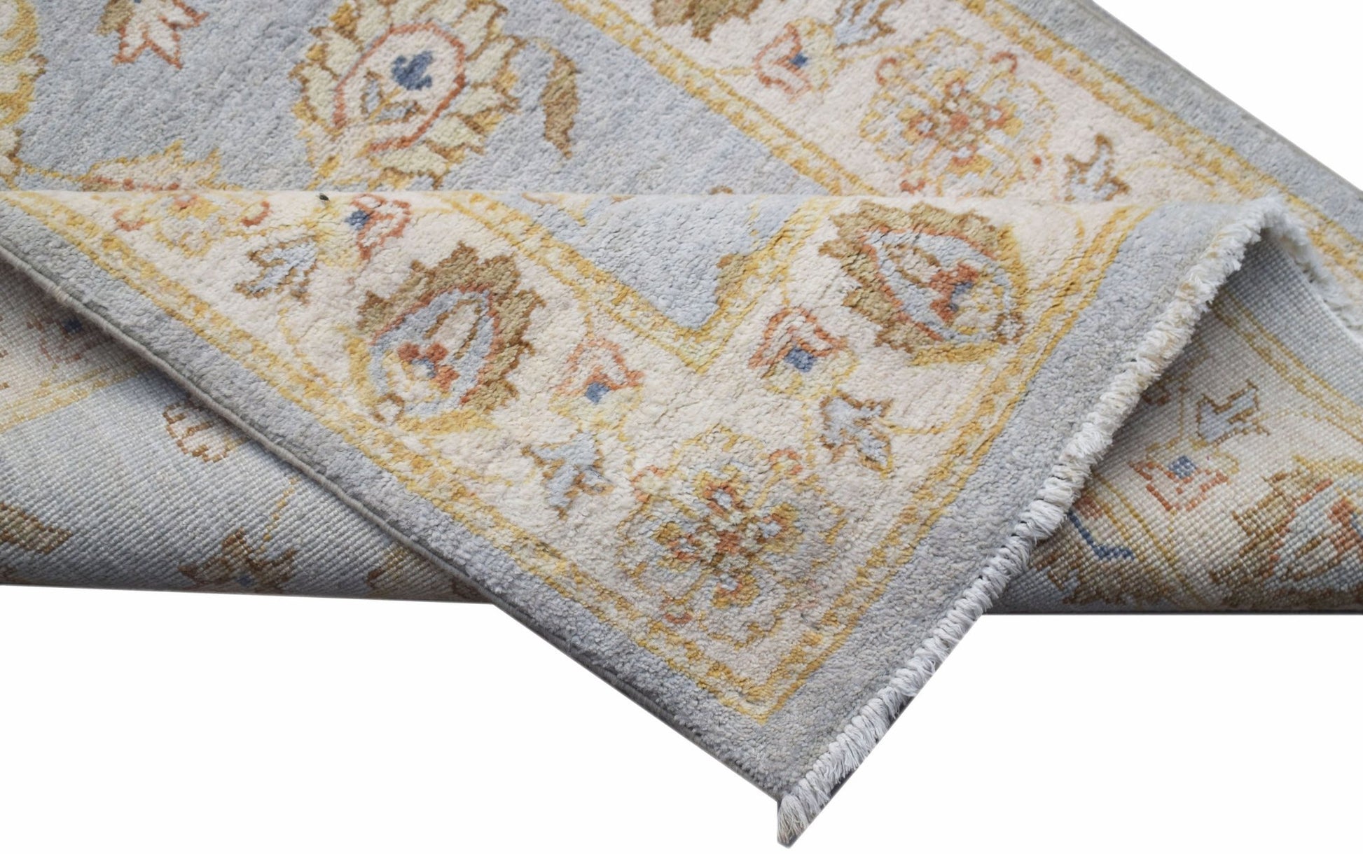 A handwoven Afghan Chobi runner featuring traditional floral patterns in soft blue and beige tones.
