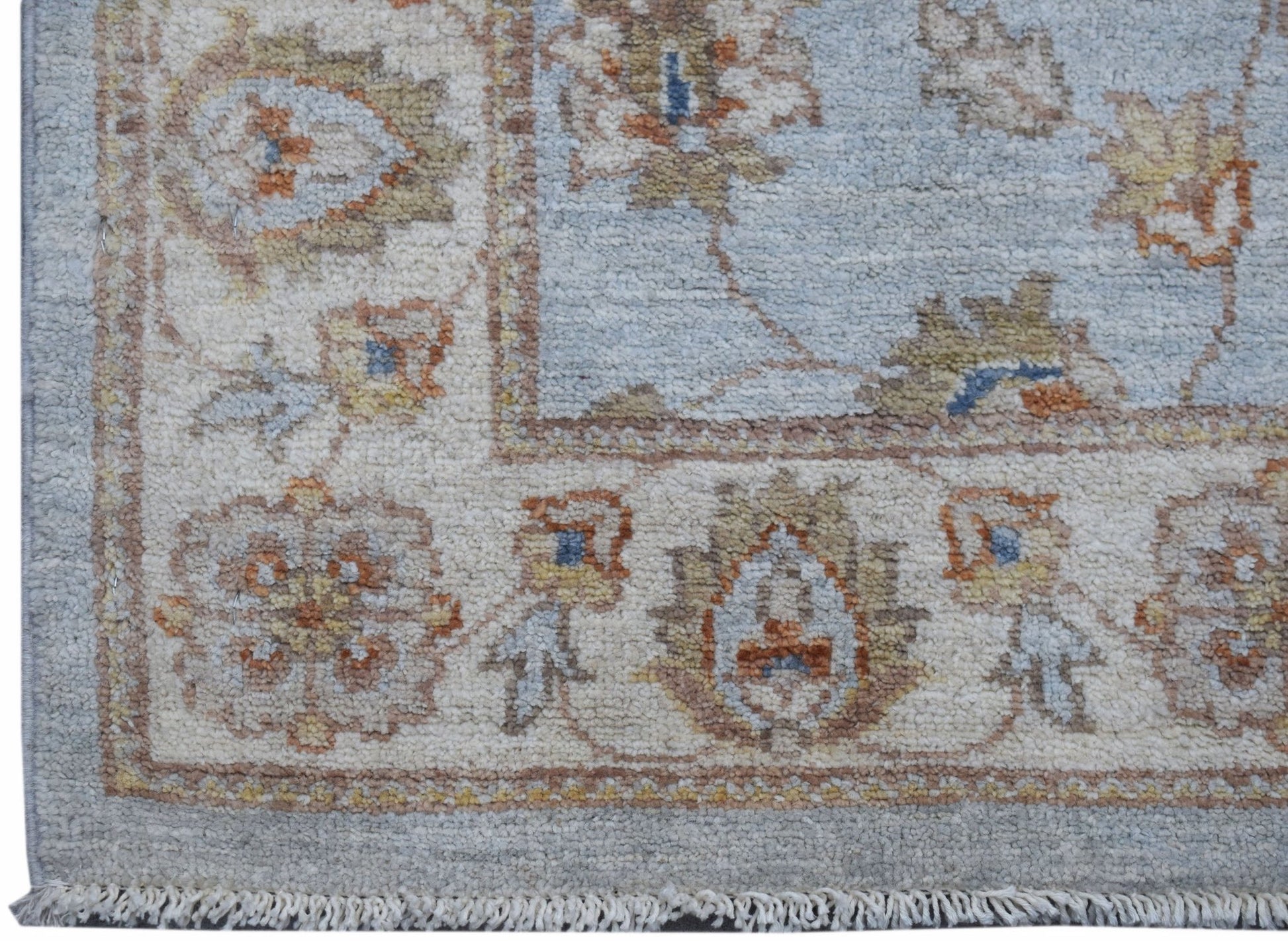 A handwoven Afghan Chobi runner featuring traditional floral patterns in soft blue and beige tones.