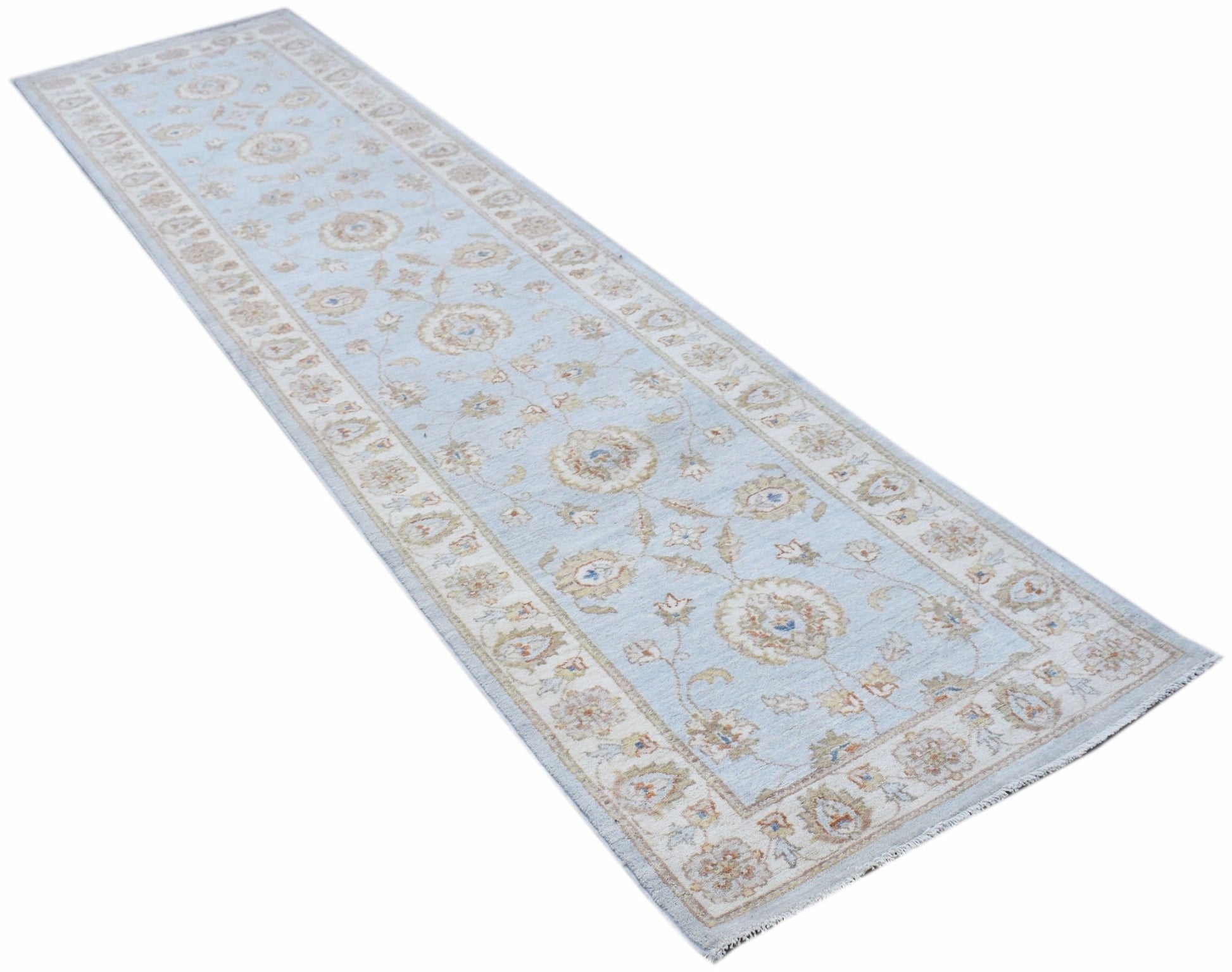 A handmade Afghan Chobi runner rug featuring a light blue field with traditional floral patterns.