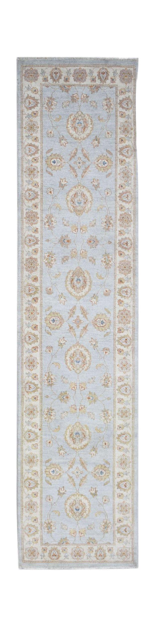 A handmade Afghan Chobi runner rug featuring a traditional floral pattern in soft blue and beige.