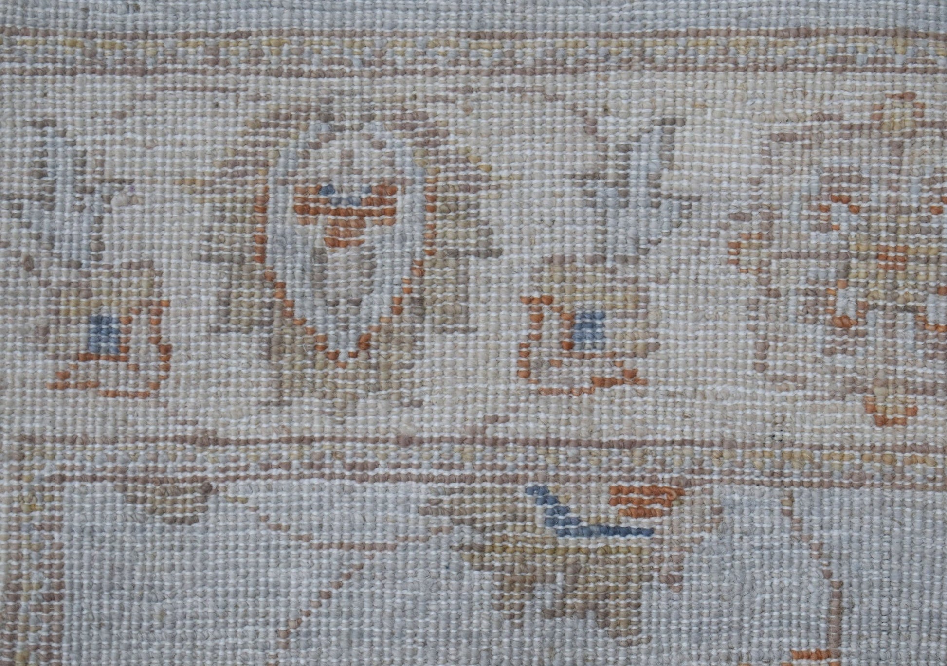 A close-up of an Afghan Chobi runner featuring traditional geometric patterns in earthy tones.