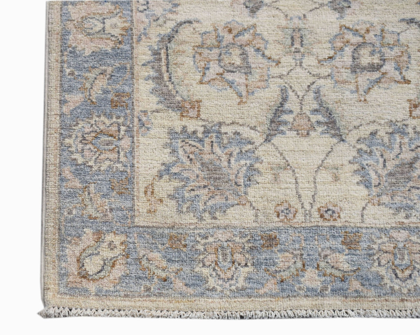 A handwoven Afghan Chobi runner featuring a traditional floral pattern in soft blue and beige tones.