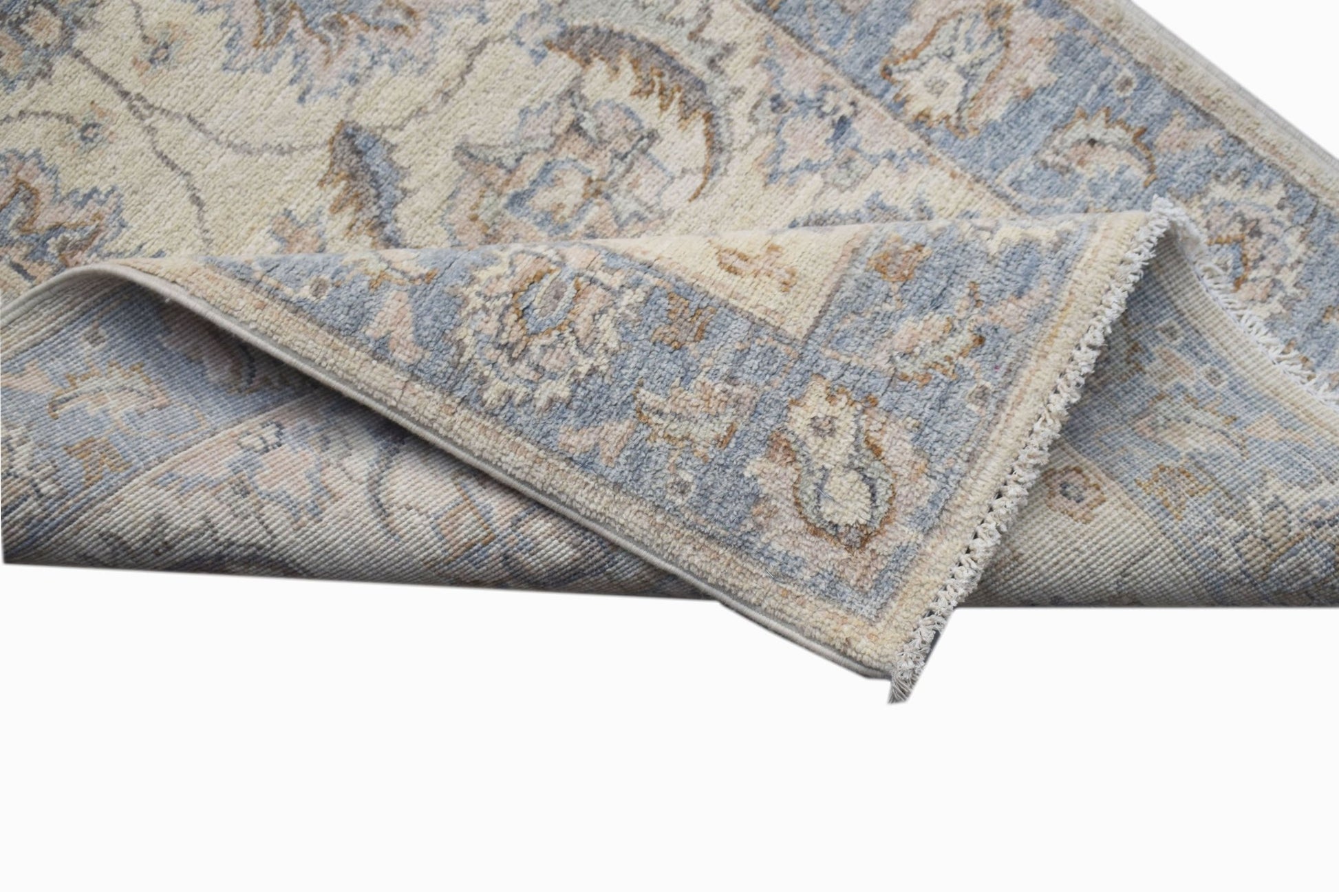 A handwoven Afghan Chobi runner featuring a traditional floral pattern in soft blue and beige tones.