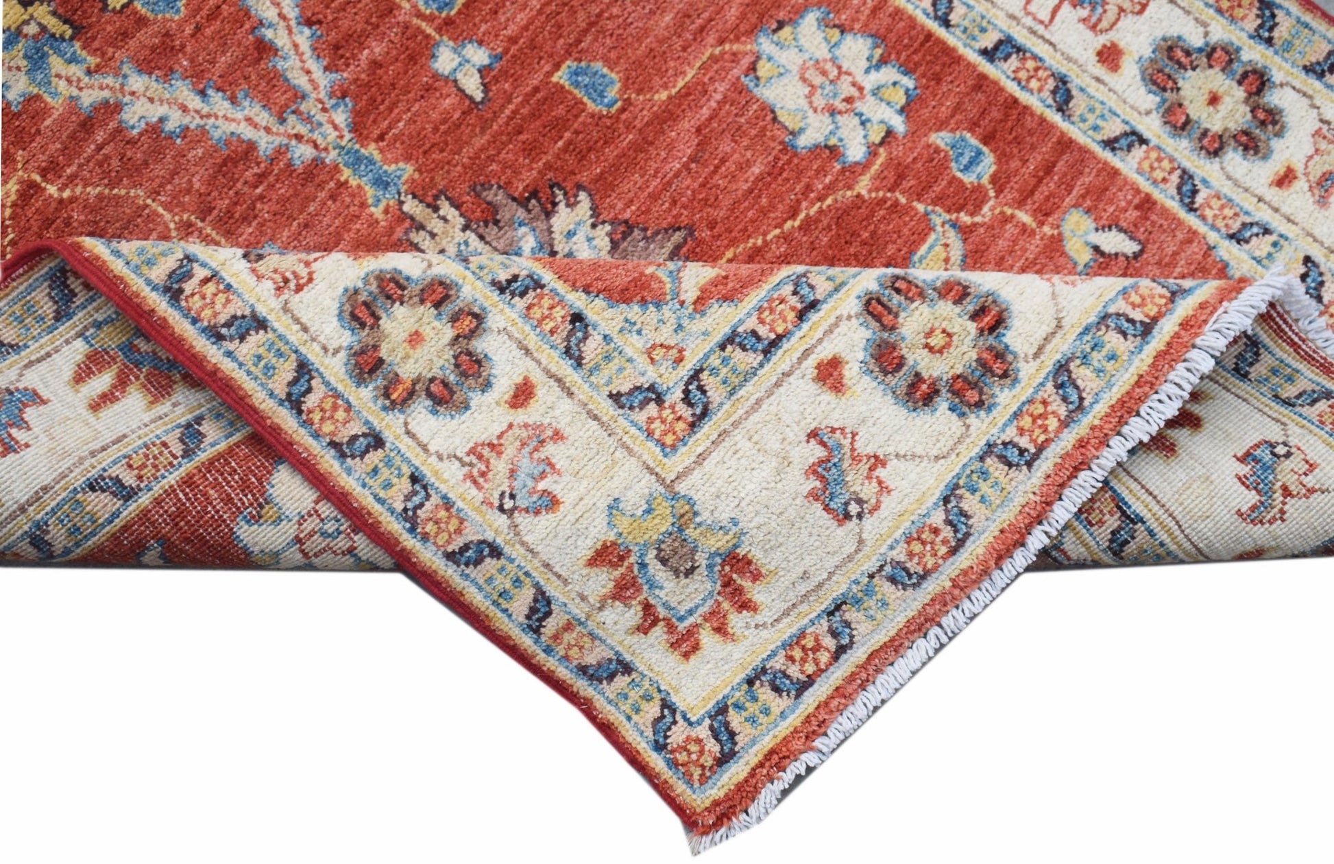 A handwoven Afghan Chobi runner featuring a traditional floral pattern in red and cream tones.
