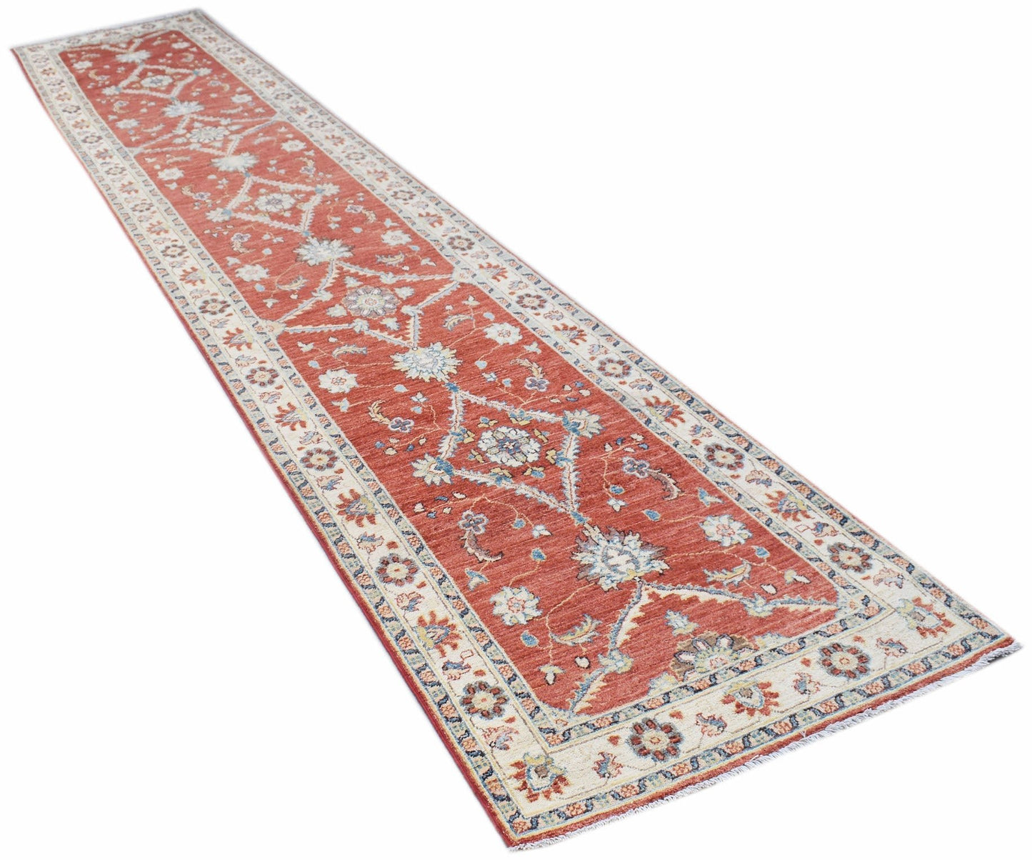 A handmade Afghan Chobi runner rug featuring a traditional floral pattern in red and cream tones.