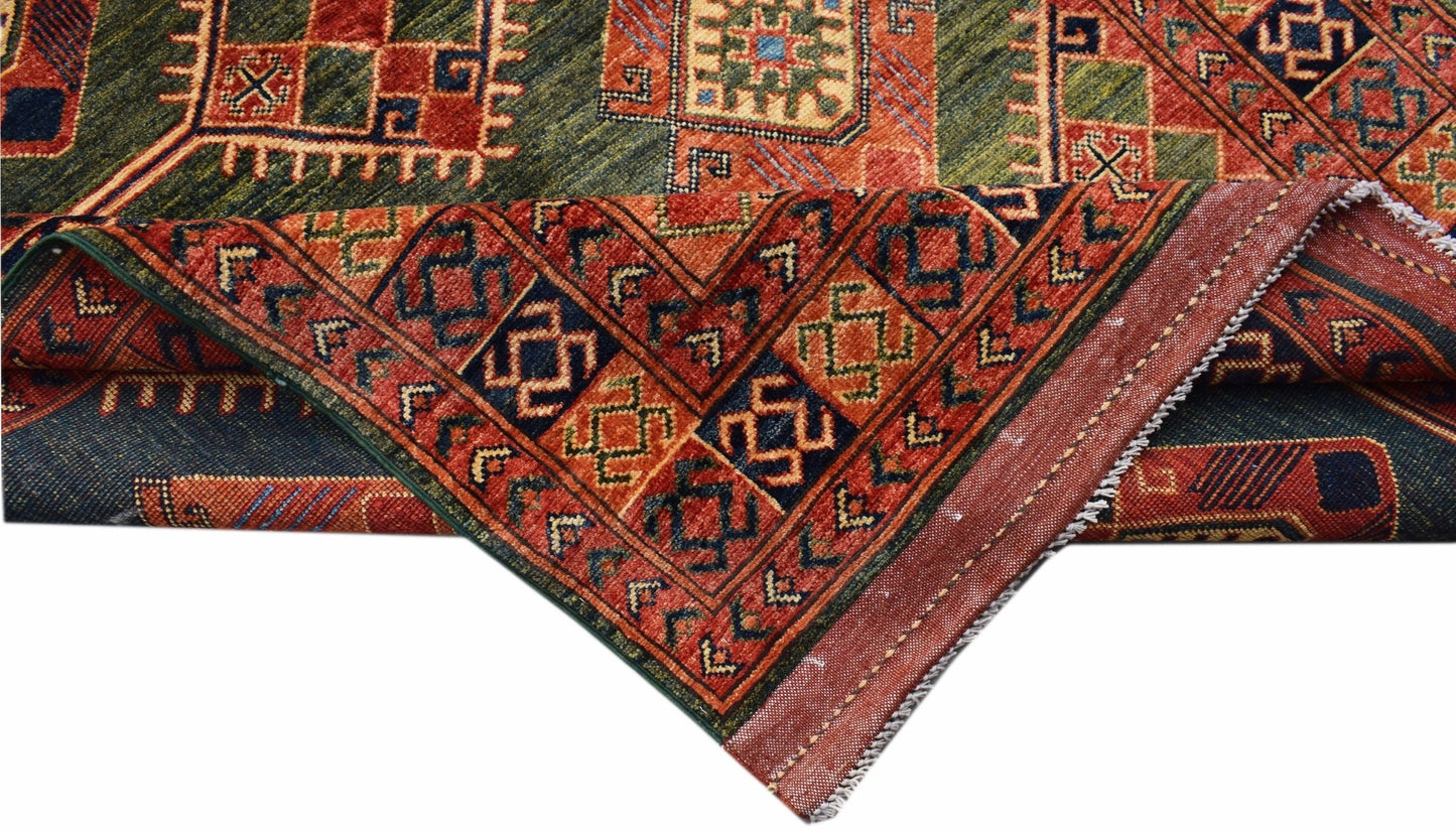 A handwoven Afghan Chobi runner featuring traditional geometric patterns in red and green wool.