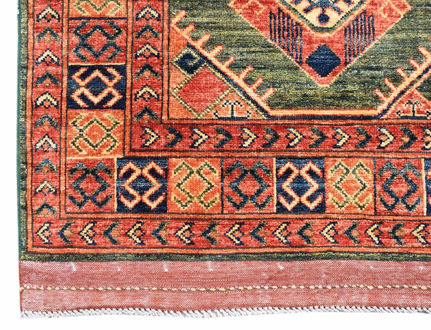A handmade Afghan Chobi runner featuring traditional geometric patterns in red, blue, and green.