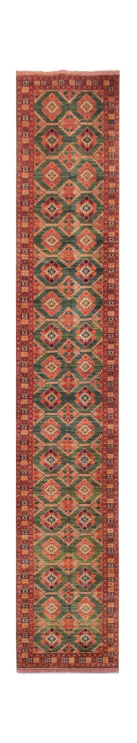 A long, handwoven Afghan Chobi runner rug featuring a repeating diamond pattern in green and red.
