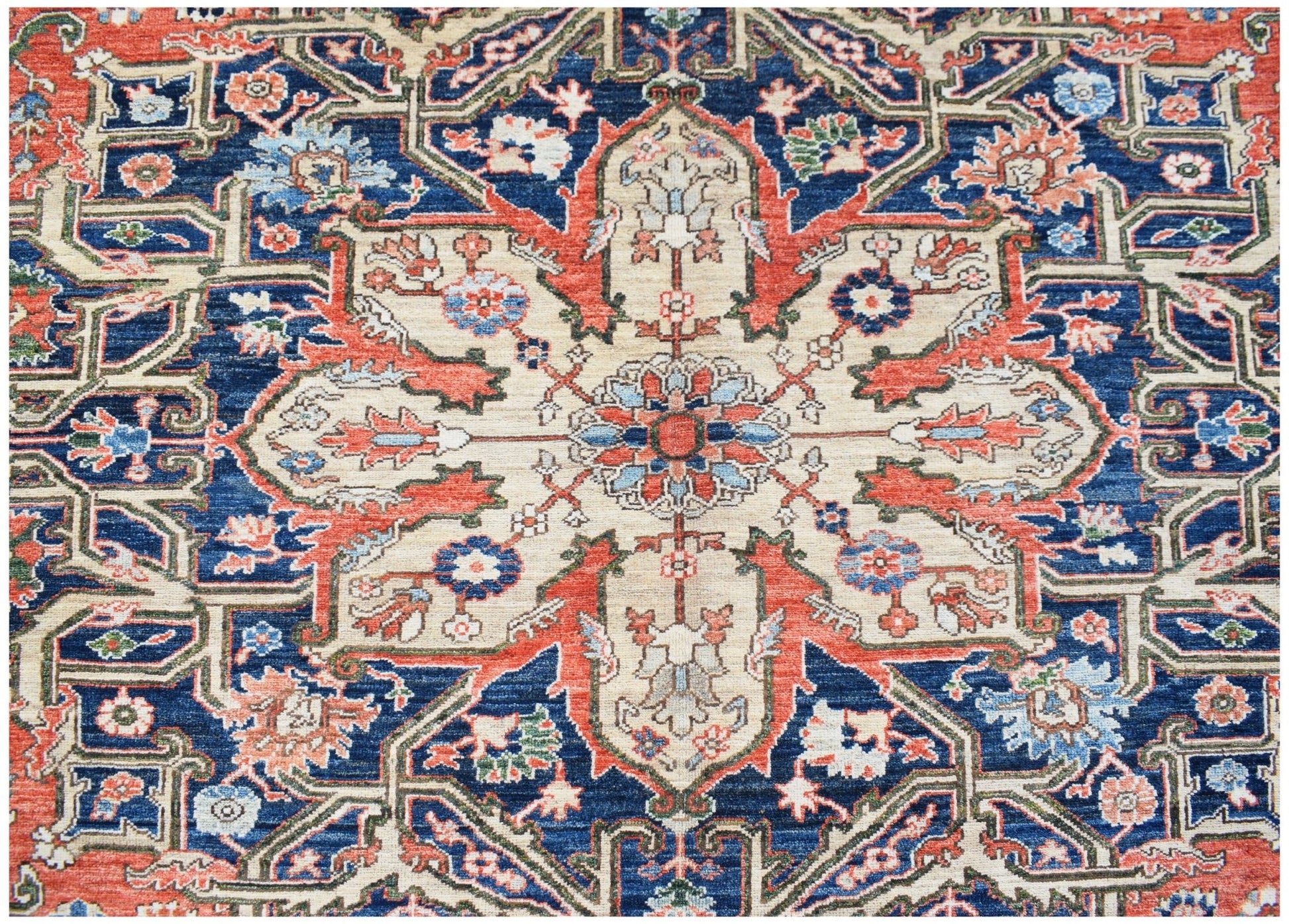 A handmade Afghan Chobi rug featuring a traditional Heriz geometric pattern in blue and red.