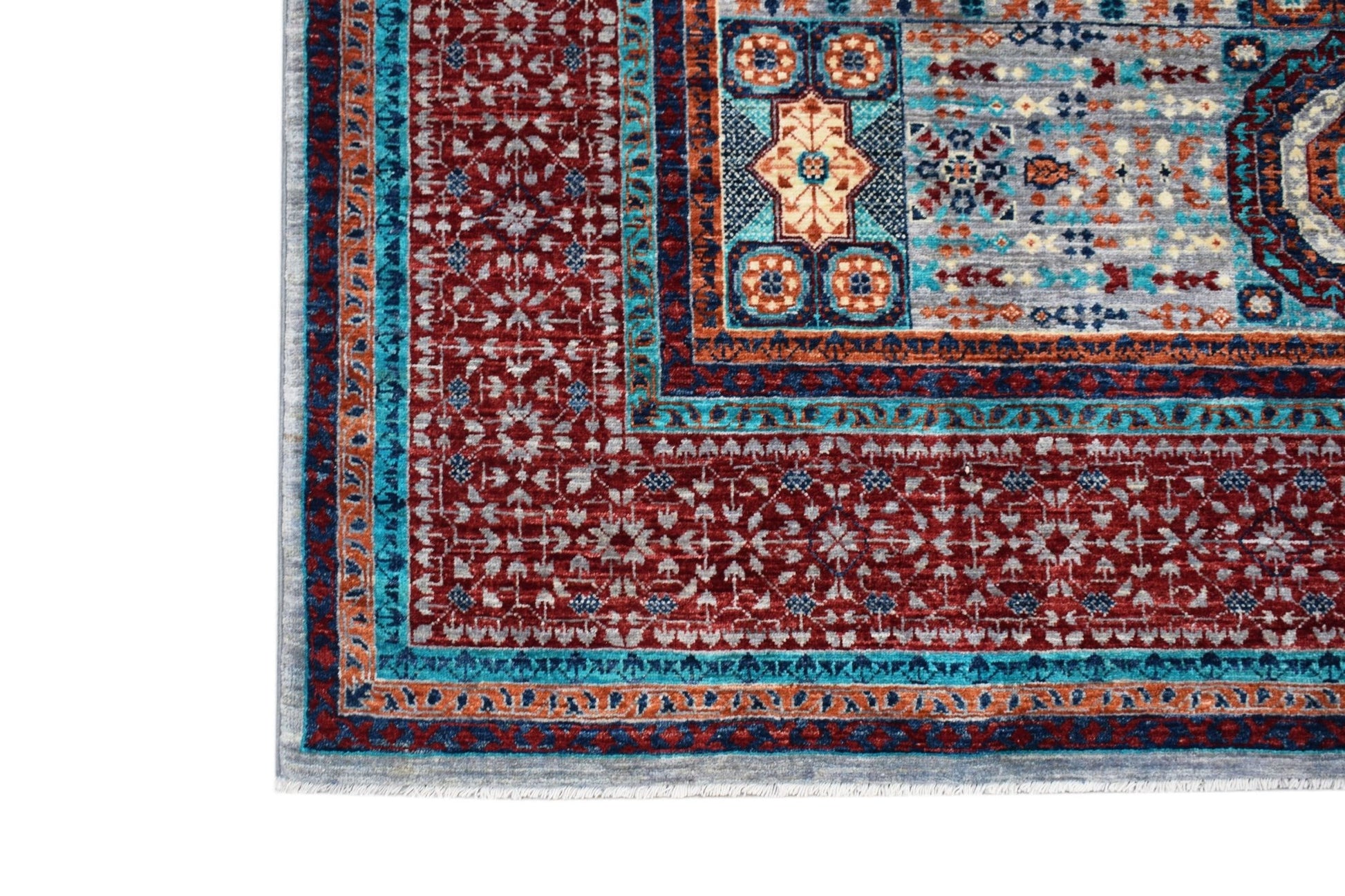 A handmade Afghan Chobi rug featuring a detailed Mamluk pattern in red, blue, and cream tones.
