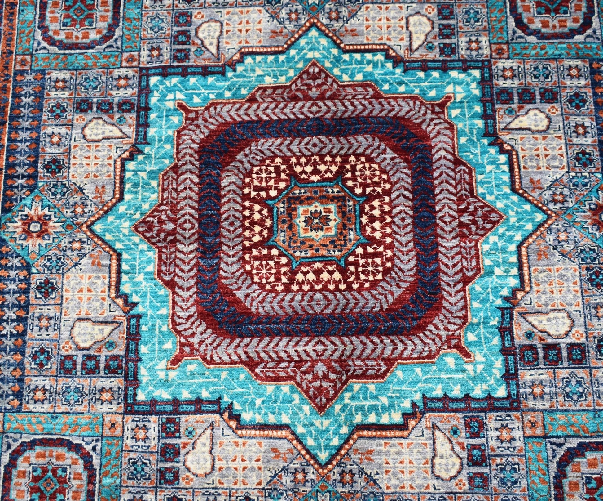 Handwoven Afghan Chobi rug featuring a detailed Mamluk medallion in shades of blue and red.