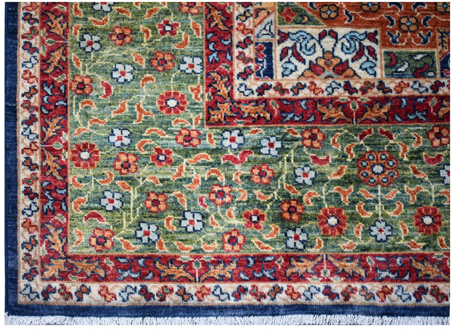 A handmade Afghan Chobi rug featuring a green field with floral patterns and a Mamluk design.