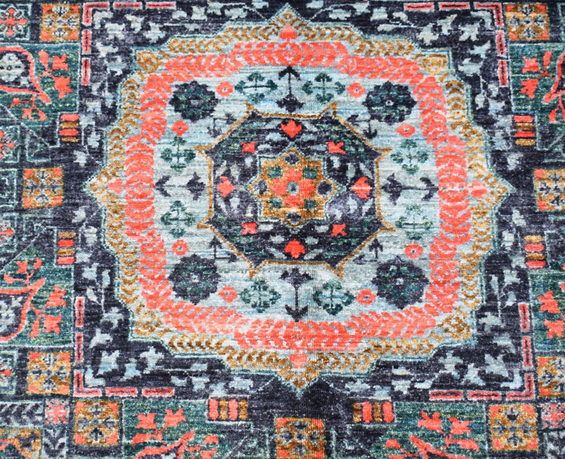 A handmade Afghan Chobi rug featuring a detailed Mamluk medallion pattern in orange and blue tones.