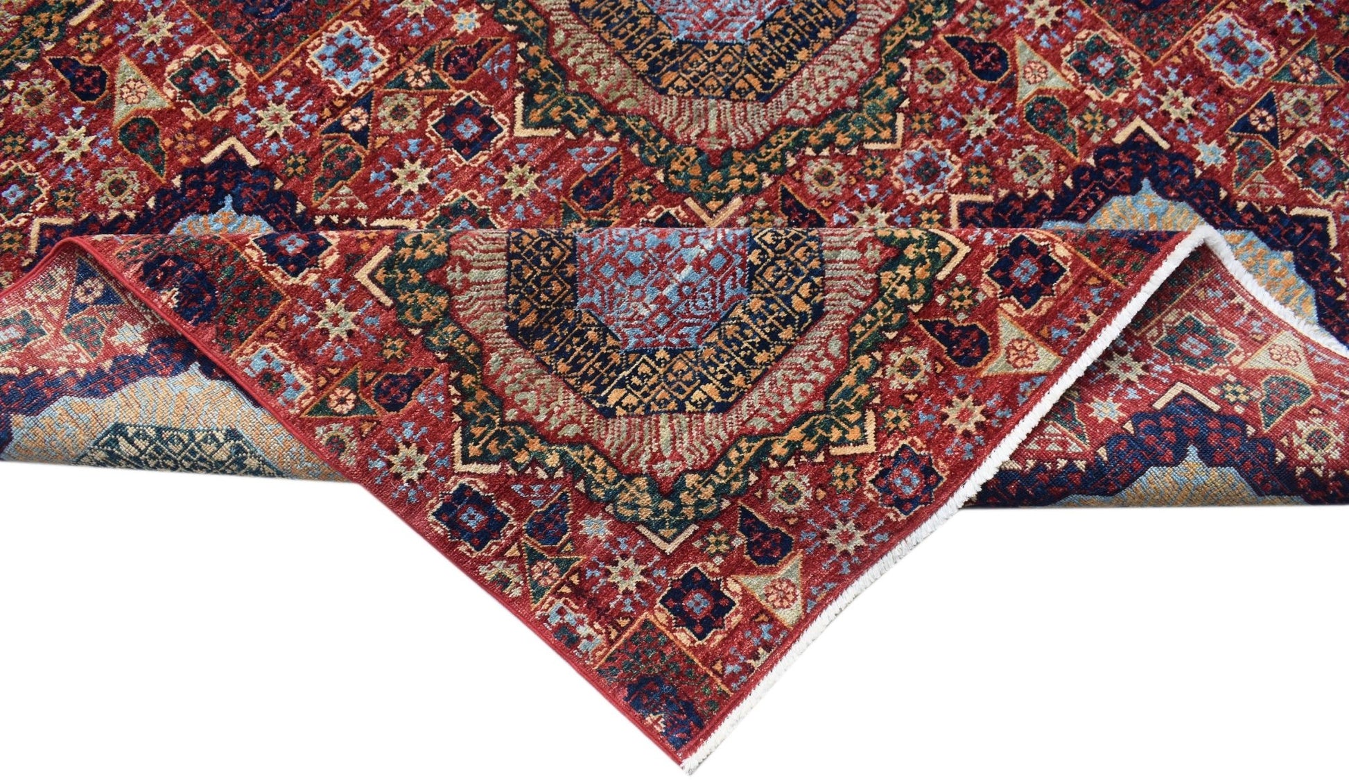 A handmade Afghan Chobi rug featuring a traditional red Mamluk pattern with intricate medallions.