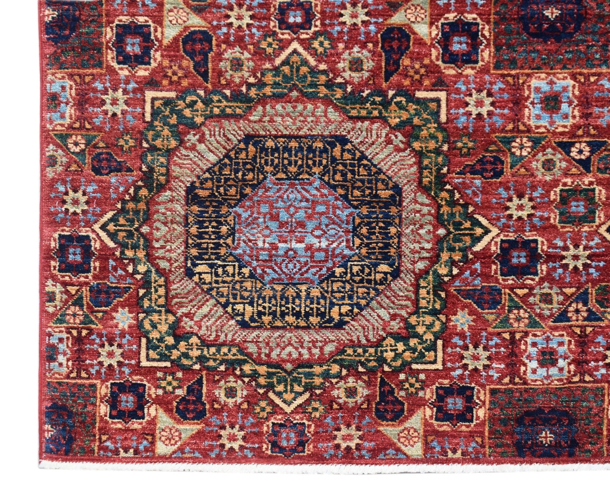 A handmade Afghan Chobi rug featuring a detailed Mamluk medallion pattern in red and blue tones.