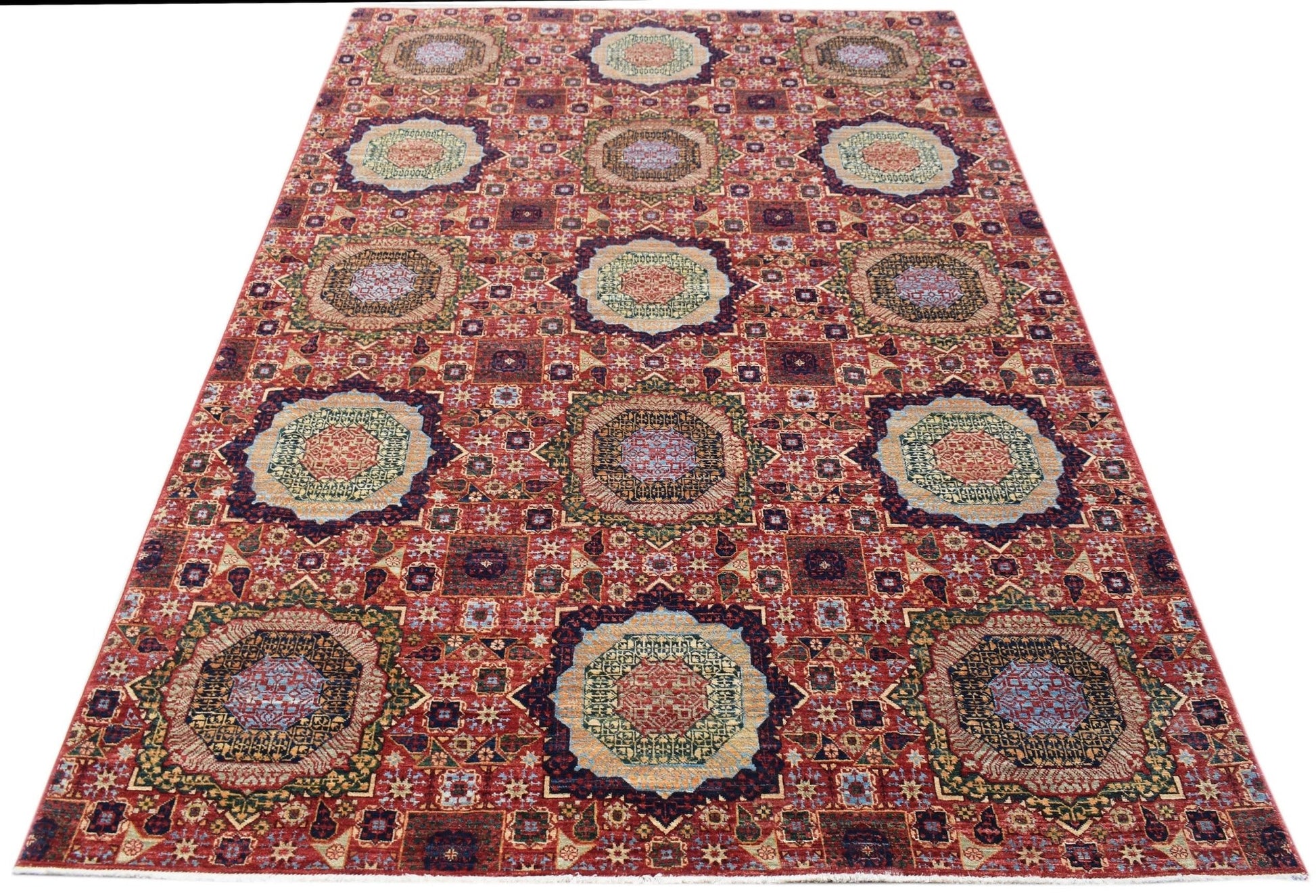 A handmade Afghan Chobi rug featuring a traditional red Mamluk pattern with detailed medallions.