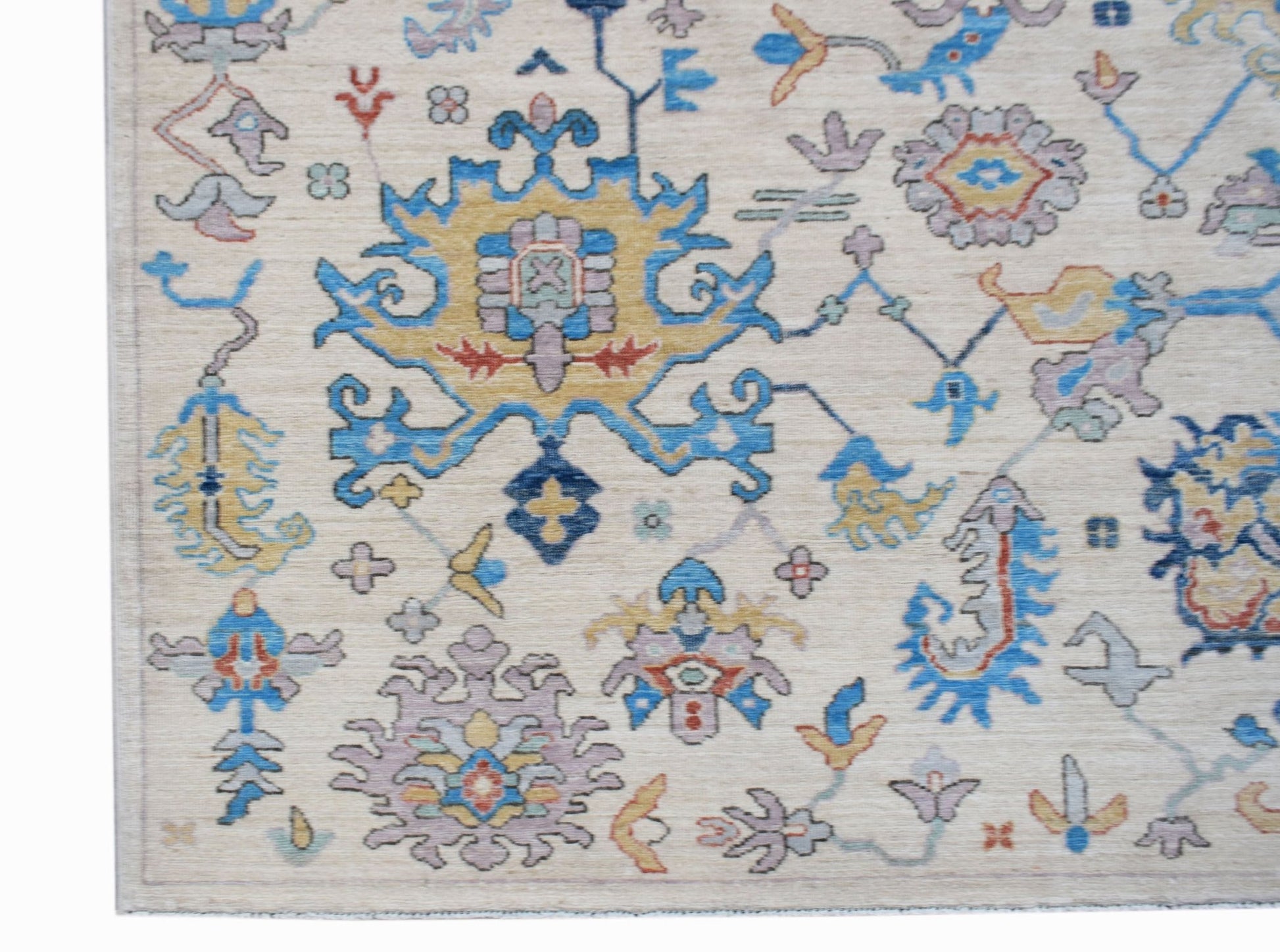 Handwoven Afghan Chobi rug featuring a traditional floral pattern in blue, yellow, and soft purple.