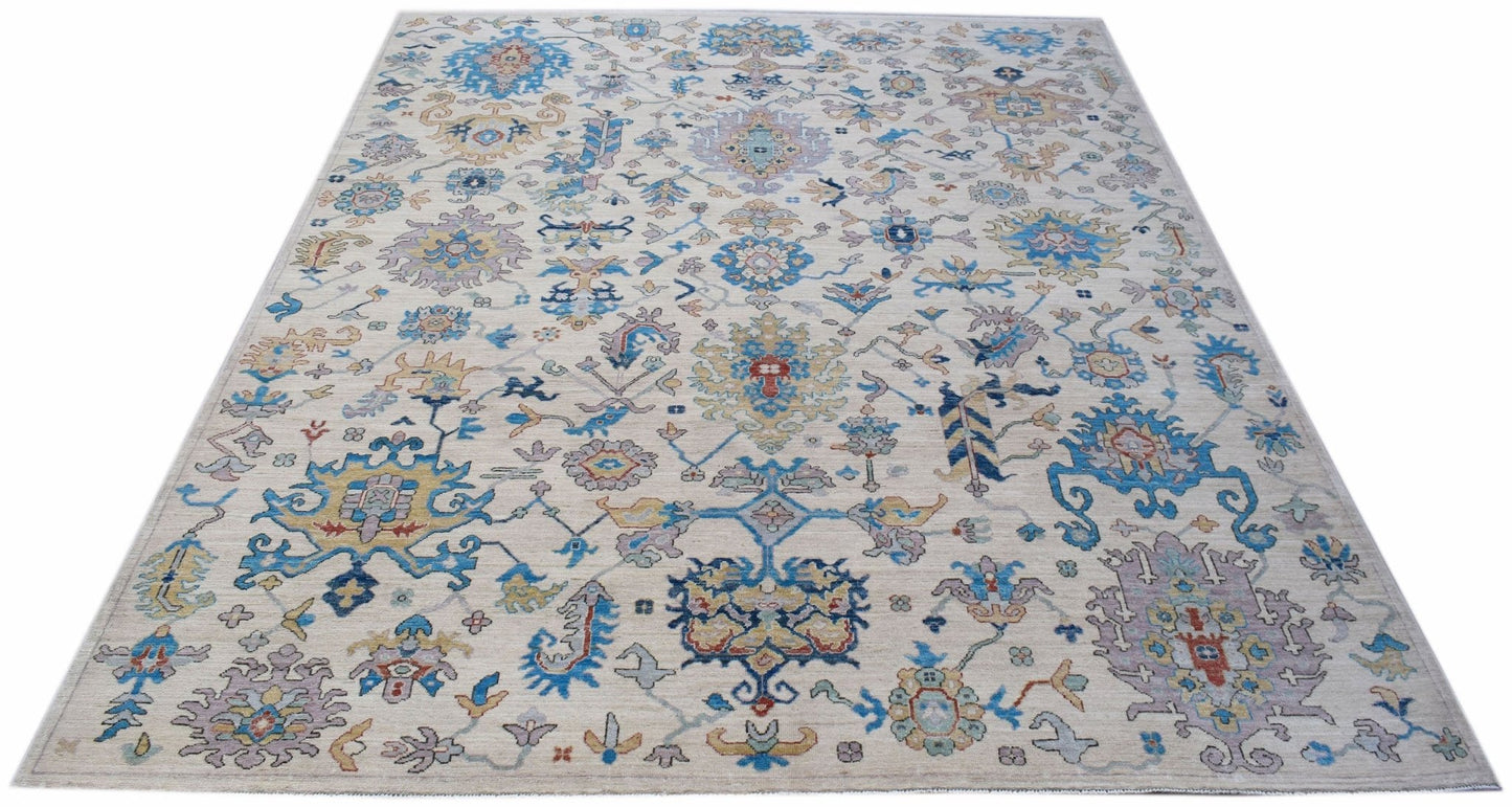 Handwoven Afghan Chobi rug featuring a traditional floral pattern in blue, gold, and cream tones.