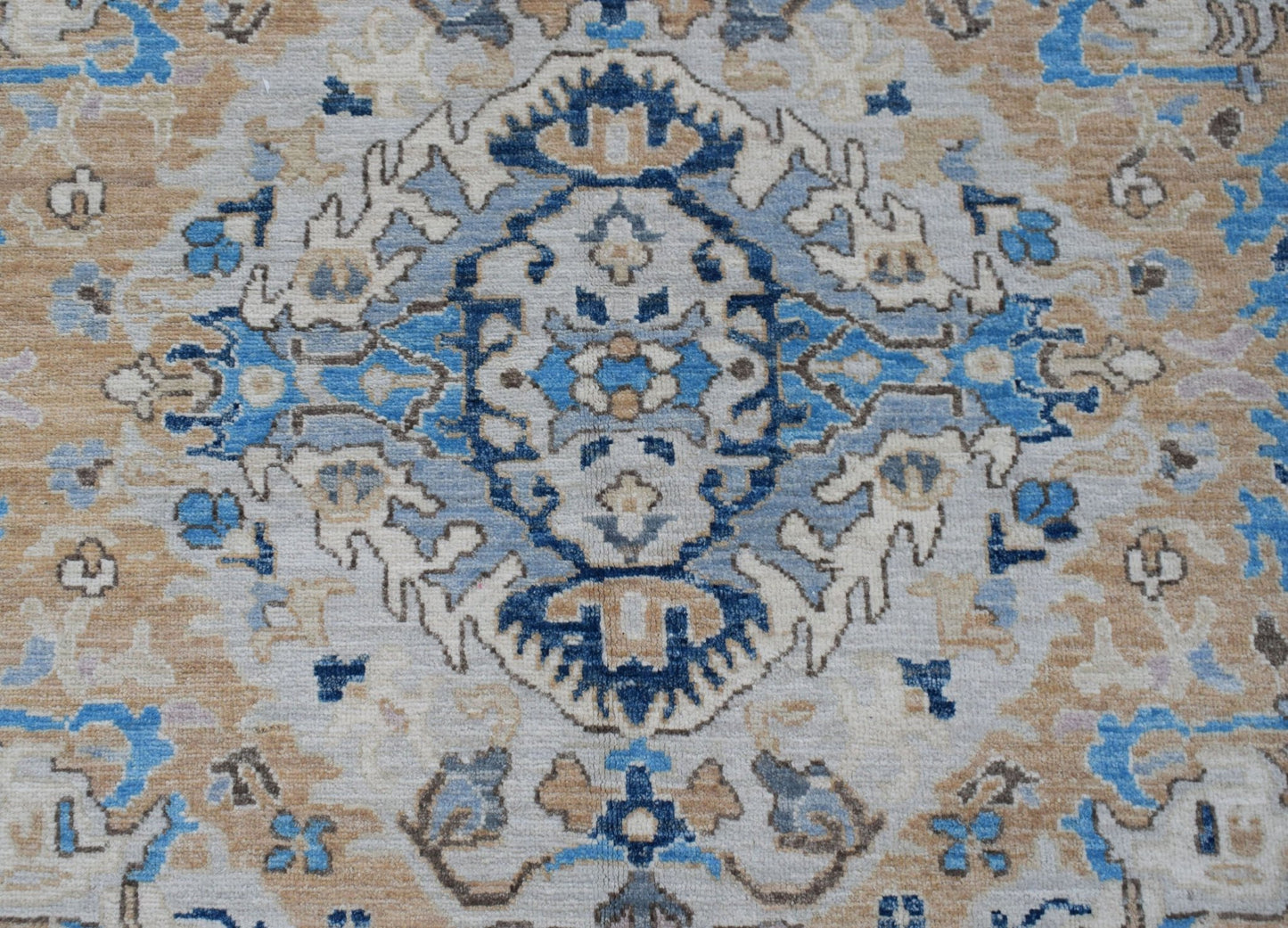 A handwoven Afghan Chobi rug featuring a traditional blue and beige floral medallion pattern.