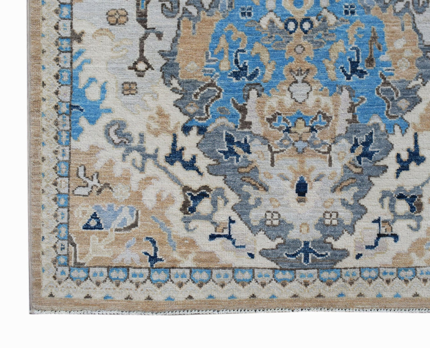 A handwoven Afghan Chobi rug featuring a traditional floral pattern in blue, beige, and grey.