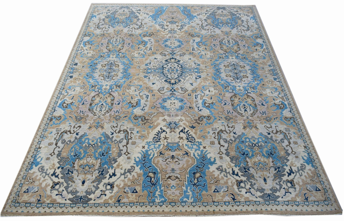 Handwoven Afghan Chobi rug featuring a traditional floral pattern in blue, beige, and grey tones.