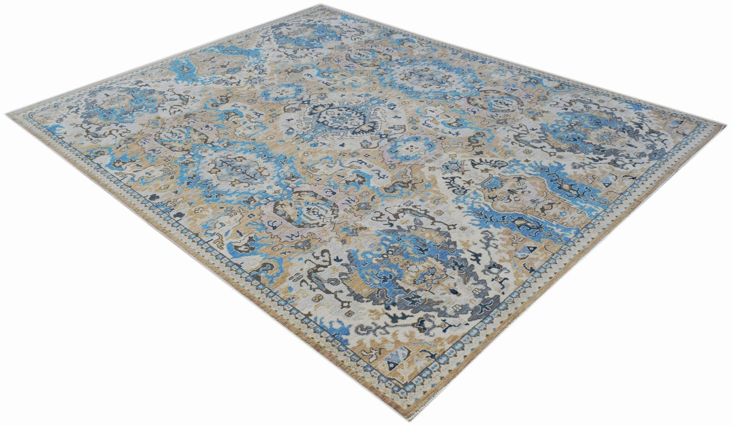A handmade Afghan Chobi rug featuring a traditional floral pattern in blue, beige, and grey tones.