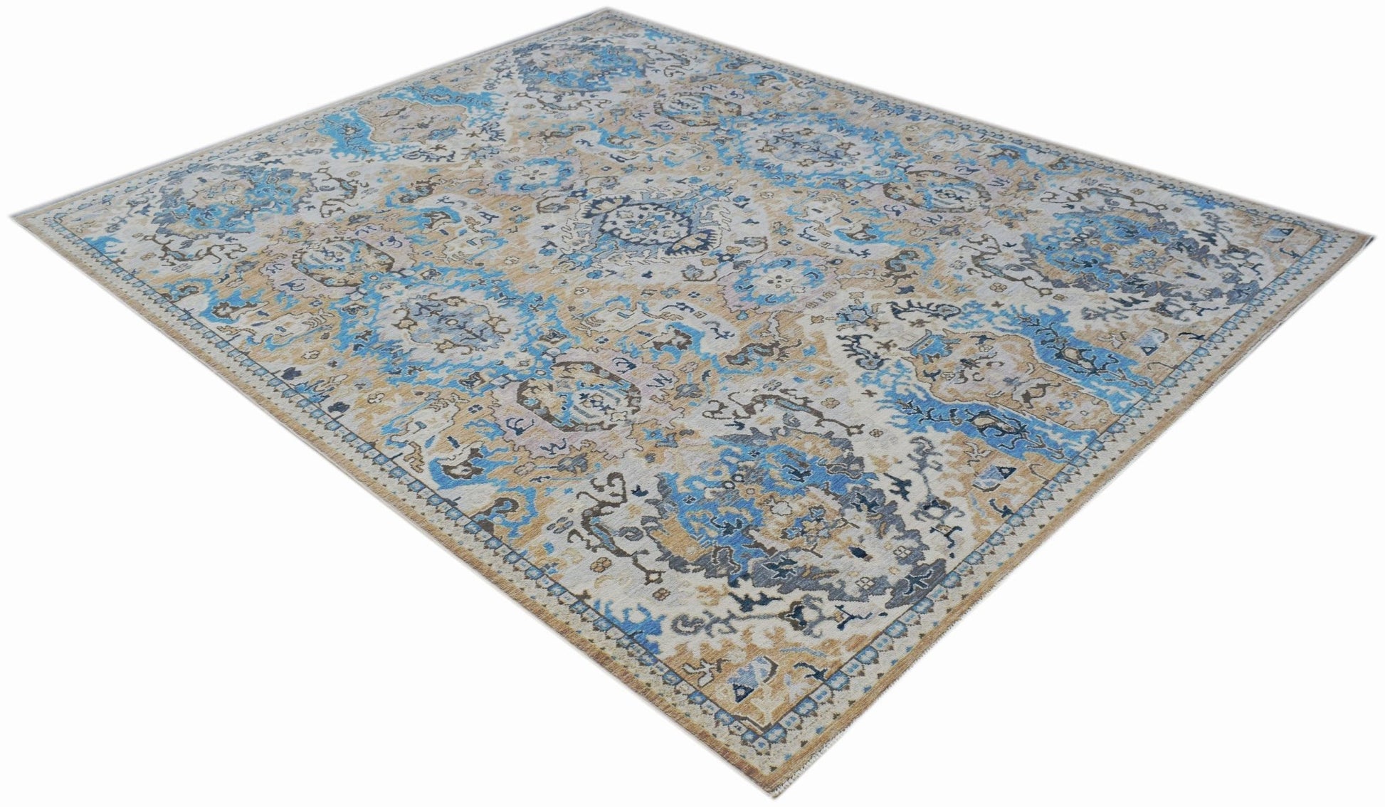 A handmade Afghan Chobi rug featuring a traditional floral pattern in blue, beige, and grey tones.