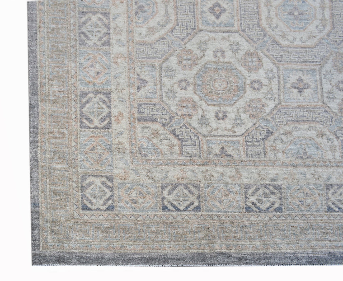 A handmade Afghan Chobi rug featuring a traditional geometric pattern in soft, muted earth tones.