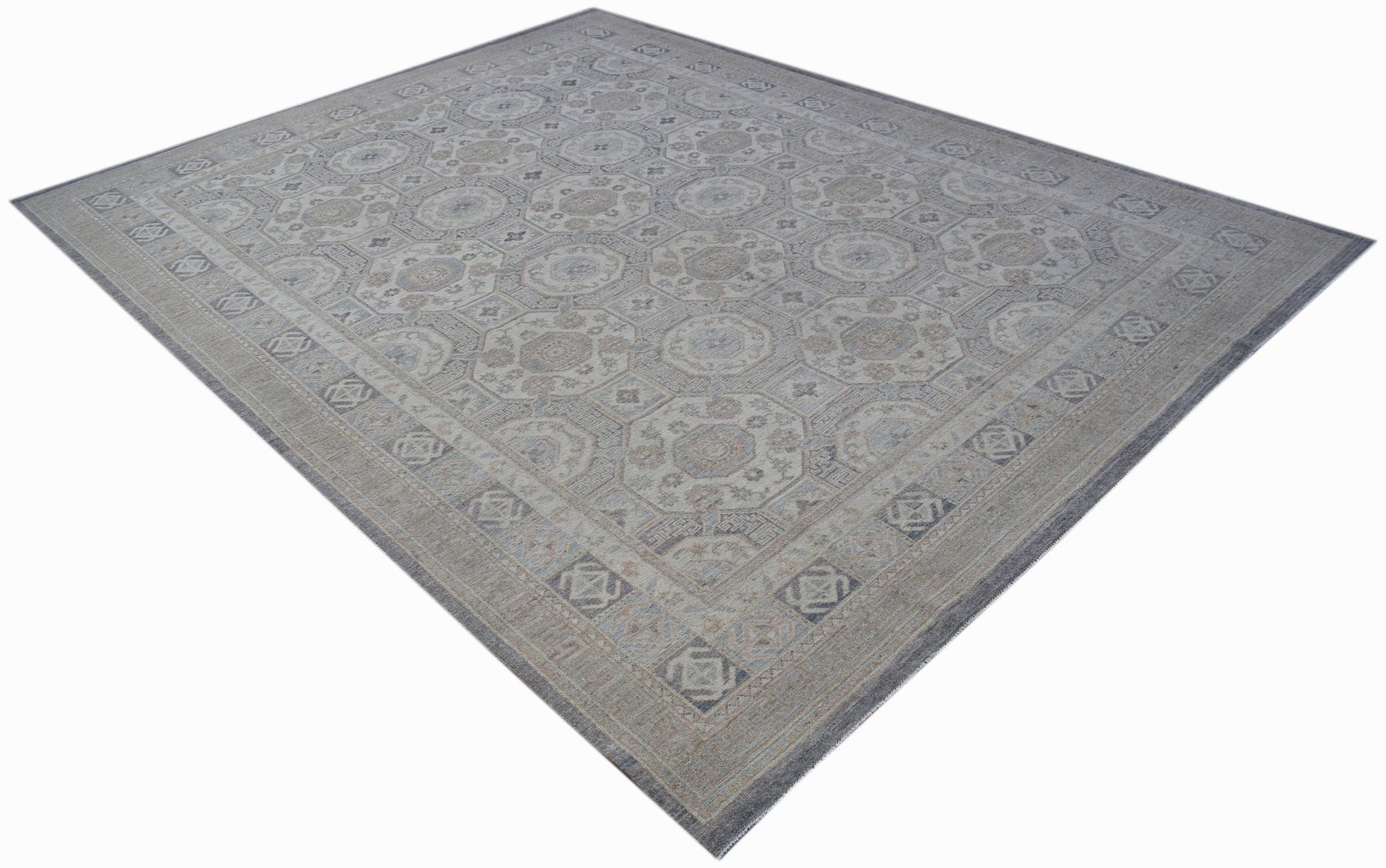 A rectangular Afghan Chobi rug featuring a traditional geometric pattern in muted earth tones.