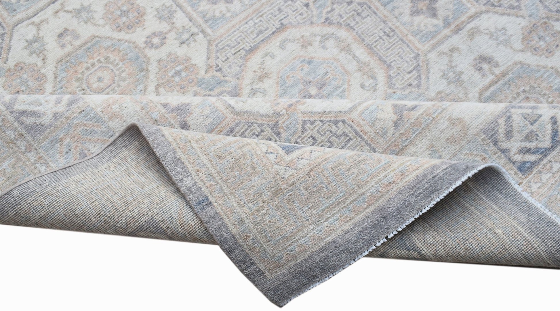 A handwoven Afghan Chobi rug featuring a traditional geometric pattern in soft neutral tones.