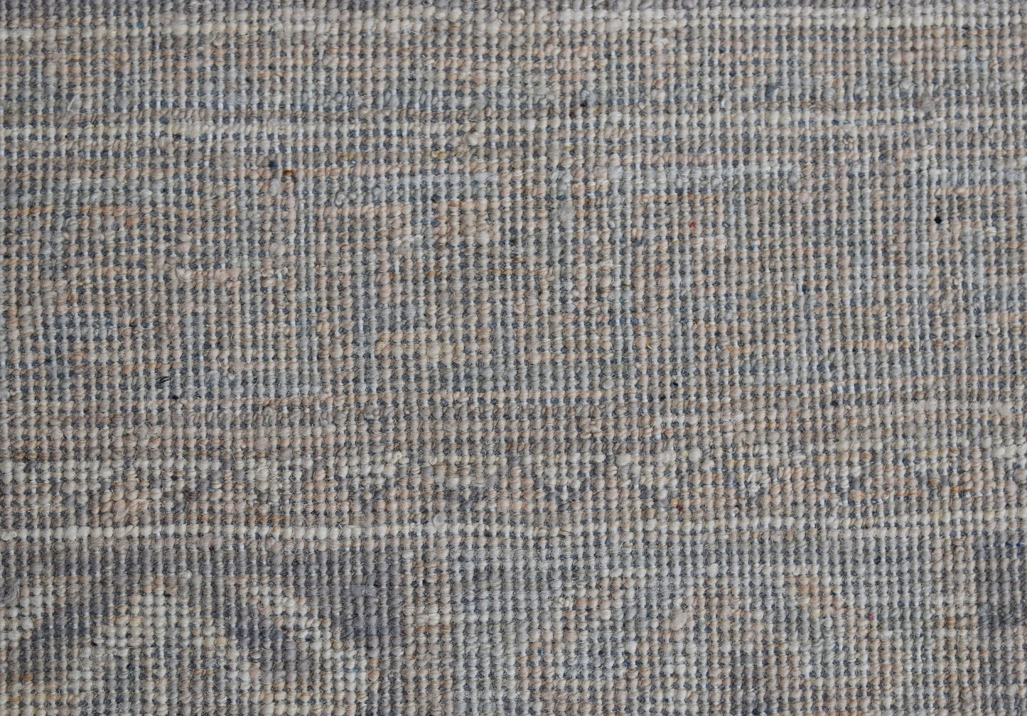 A close-up view of a handwoven Afghan Chobi rug featuring a textured, neutral-toned wool weave.