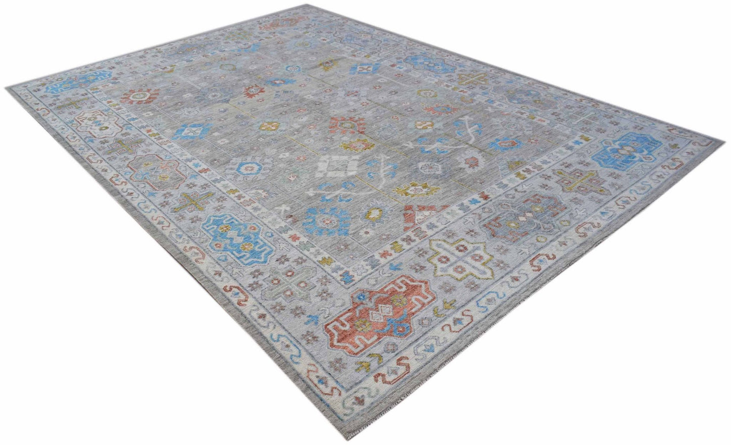 A rectangular Afghan Chobi rug featuring a grey field with colorful traditional geometric patterns.