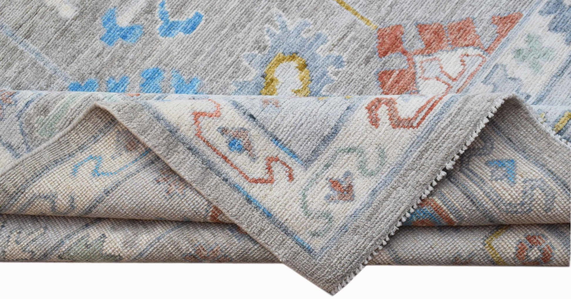 A handwoven Afghan Chobi rug featuring a traditional floral pattern in soft blue, red, and grey.
