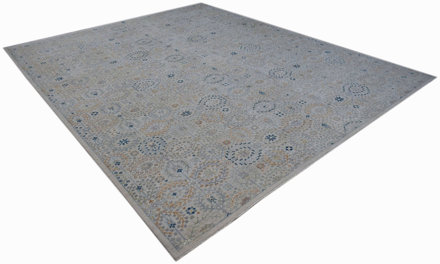 An Afghan Balkh rug featuring a traditional floral pattern in soft blue and beige tones.