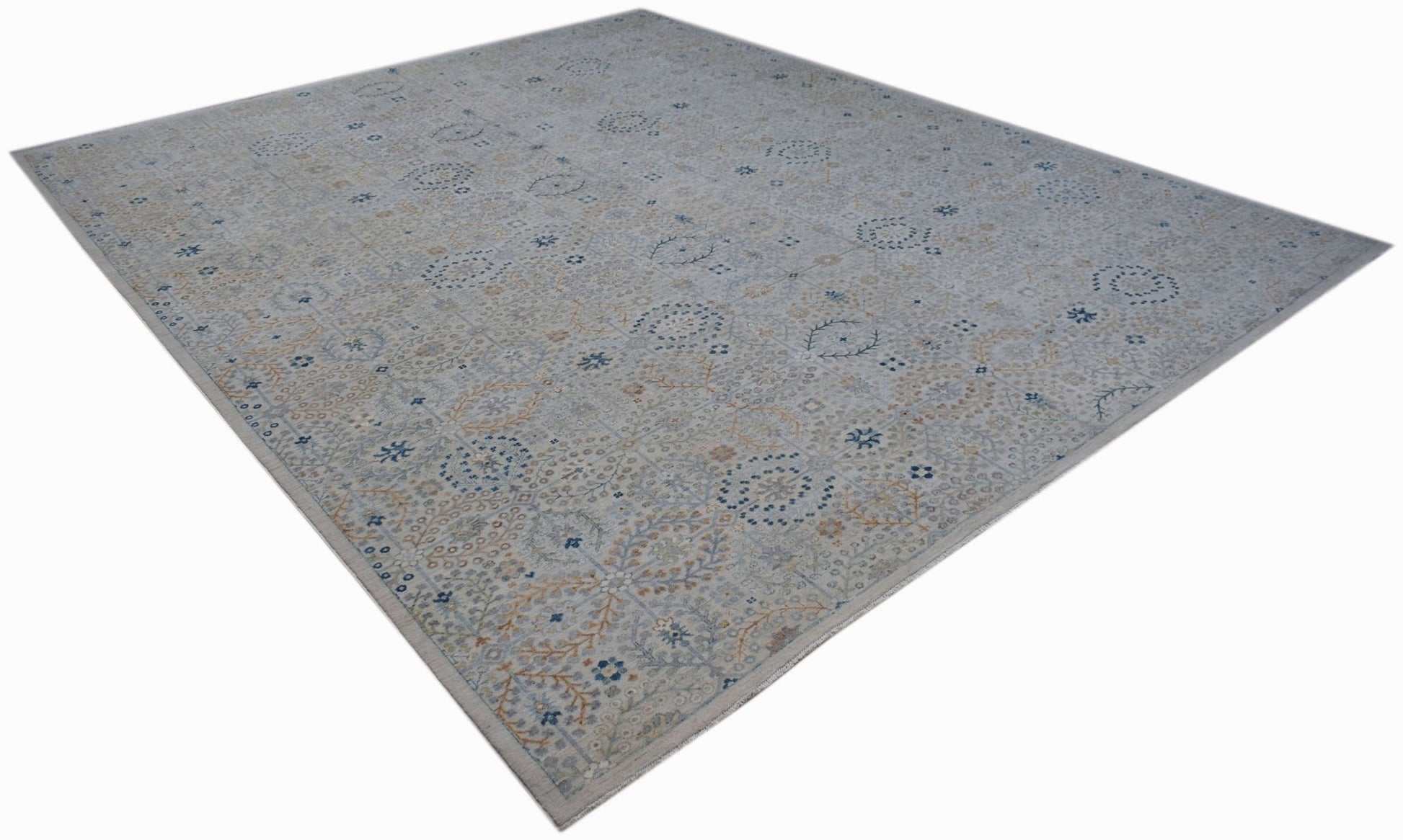 An Afghan Balkh rug featuring a traditional floral pattern in soft blue and beige tones.