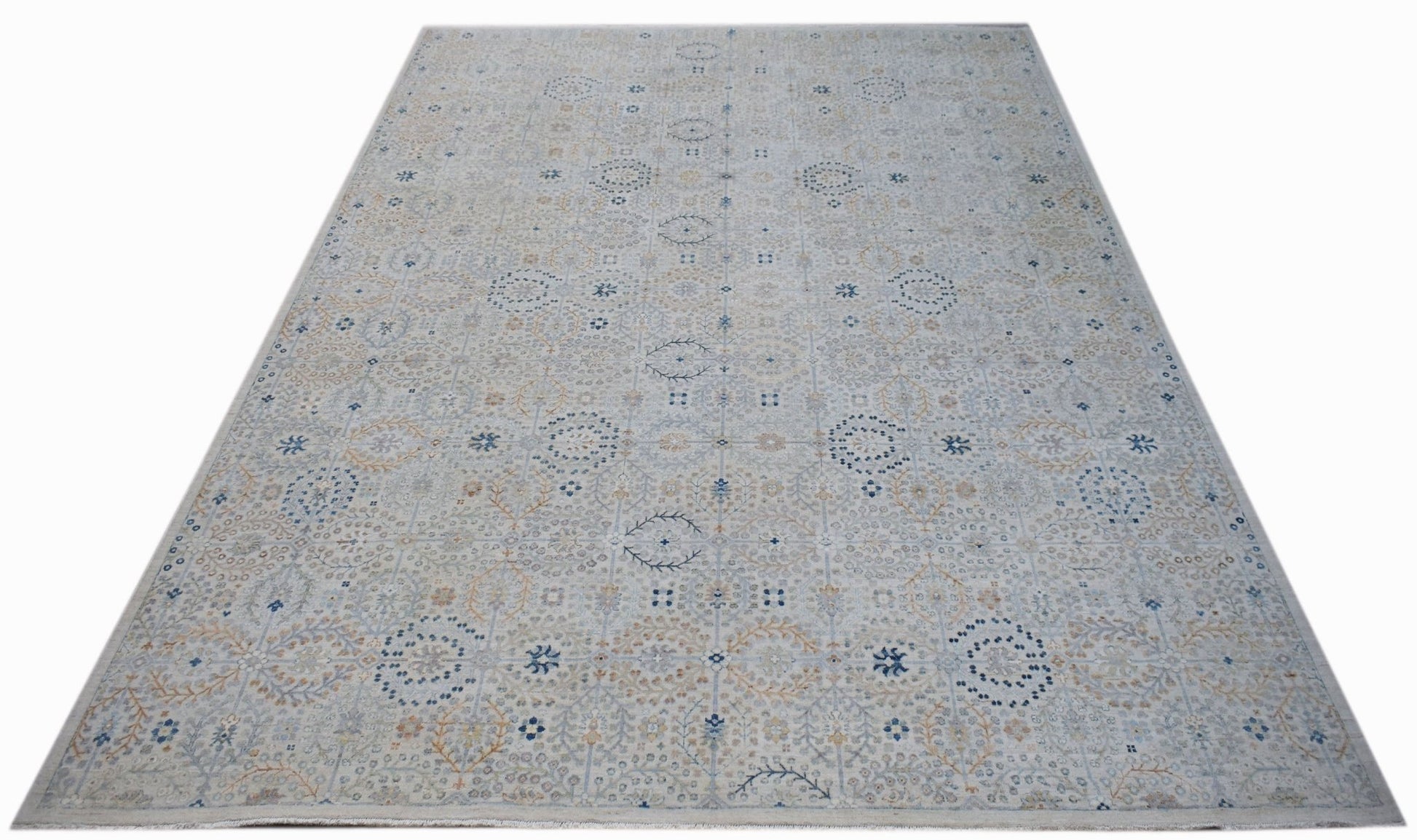 A handmade Afghan Balkh rug featuring a traditional light-toned pattern with blue floral accents.