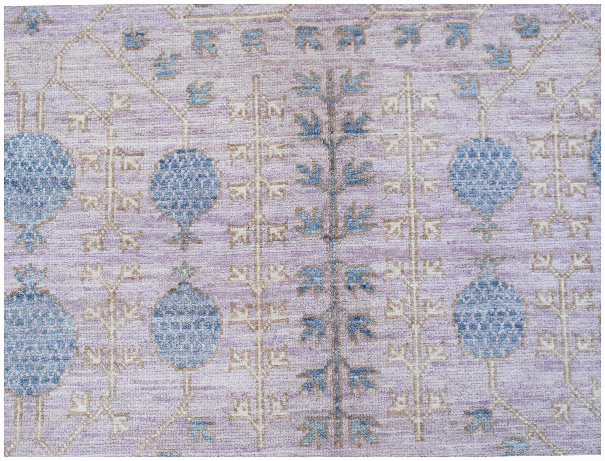 A handwoven Afghan Chobi rug featuring blue pomegranate motifs on a soft lavender background.
