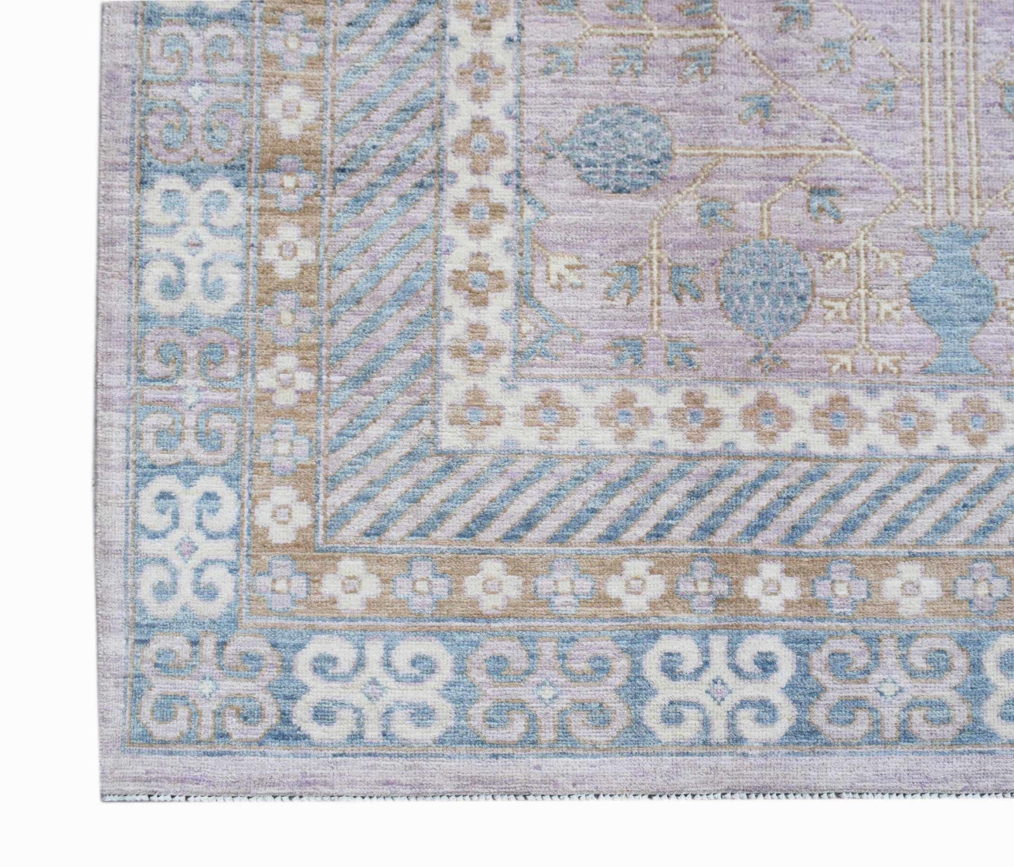 A handmade Afghan Chobi rug featuring a lavender field with blue pomegranate motifs and borders.
