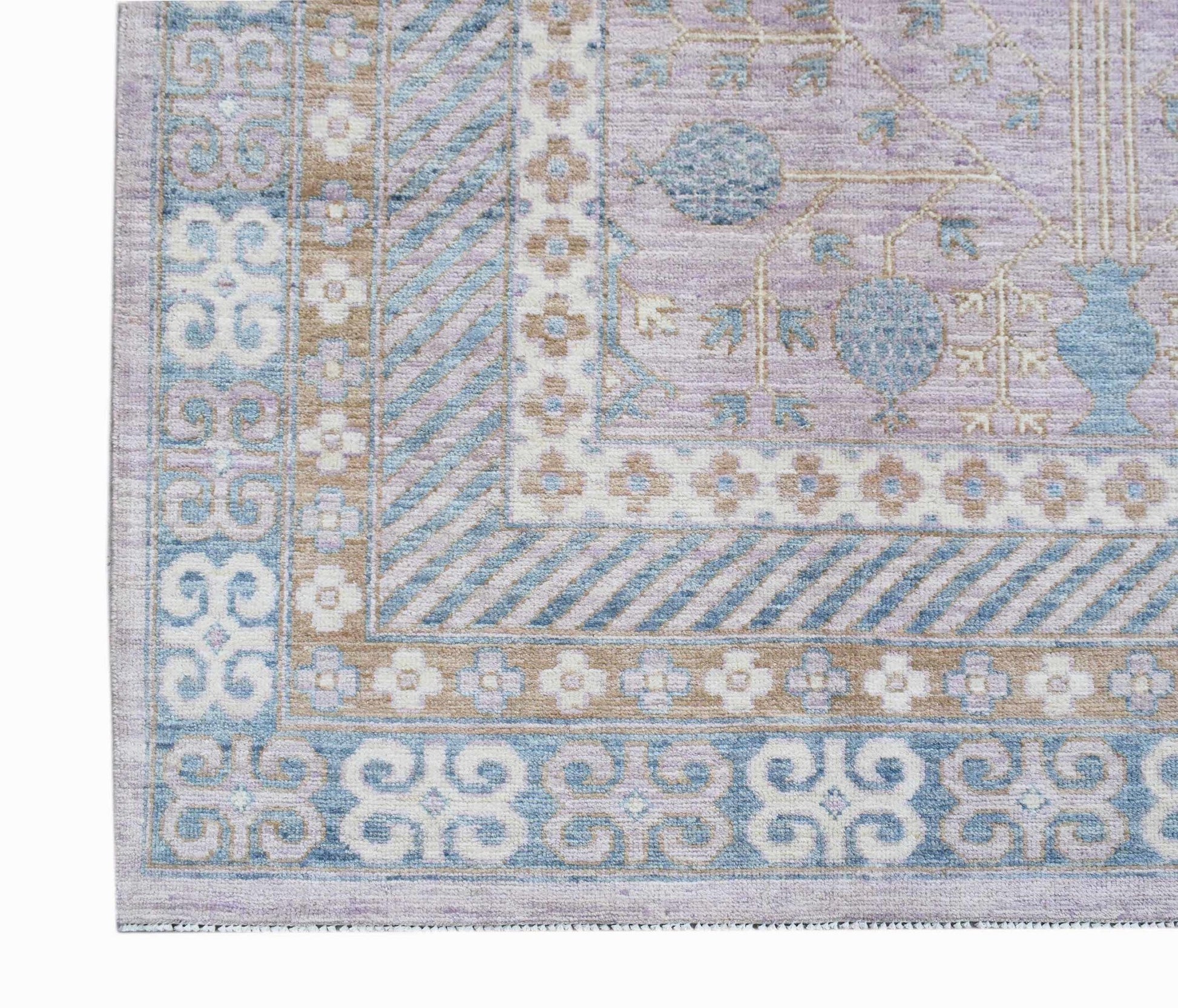 A handmade Afghan Chobi rug featuring a lavender field with blue pomegranate motifs and borders.