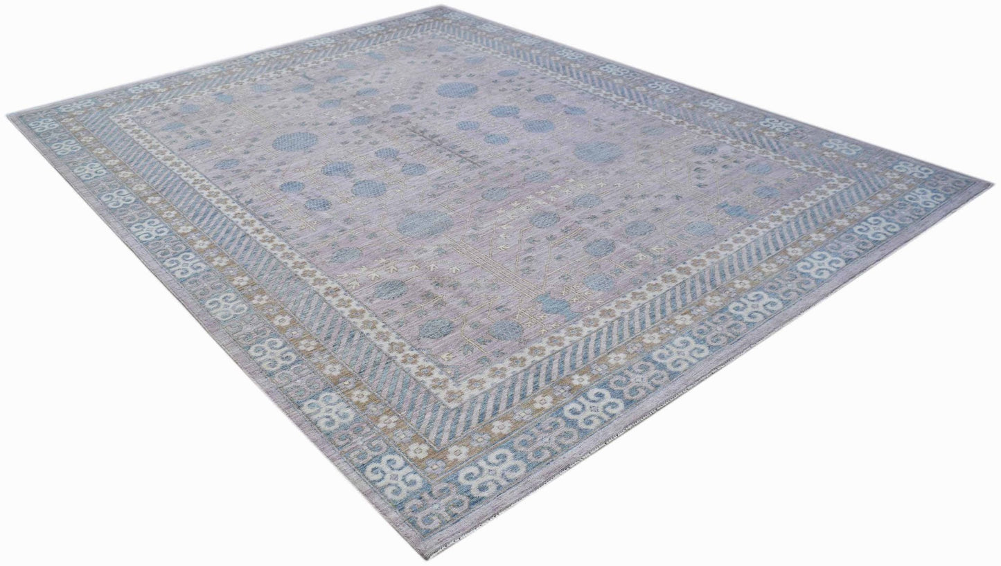 An Afghan Chobi rug featuring a light purple field with blue pomegranate motifs and ornate borders.