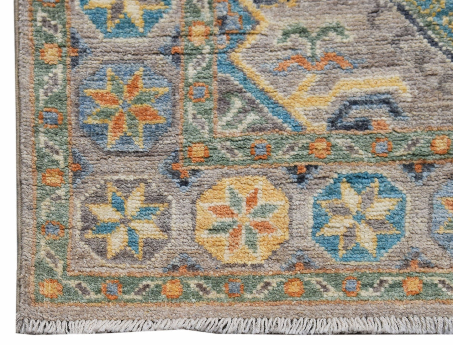A handwoven Afghan Chobi runner featuring traditional geometric floral patterns in earthy tones.