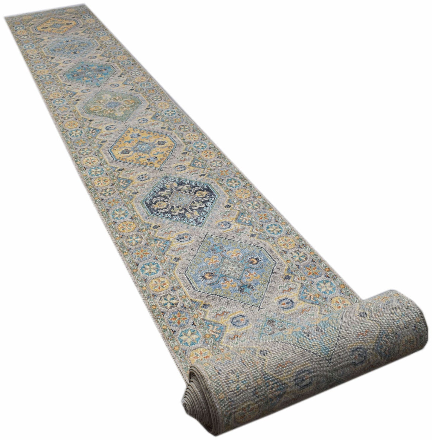 A long, handwoven Afghan Chobi runner rug featuring traditional geometric patterns in blue and gold.